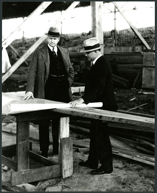 Jesse Jones with A.C. Finn looking at a blueprint