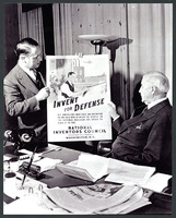 Jones holding Invest for Defense poster