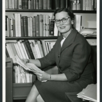 Dr. Katherine Fischer Drew seated at her desk